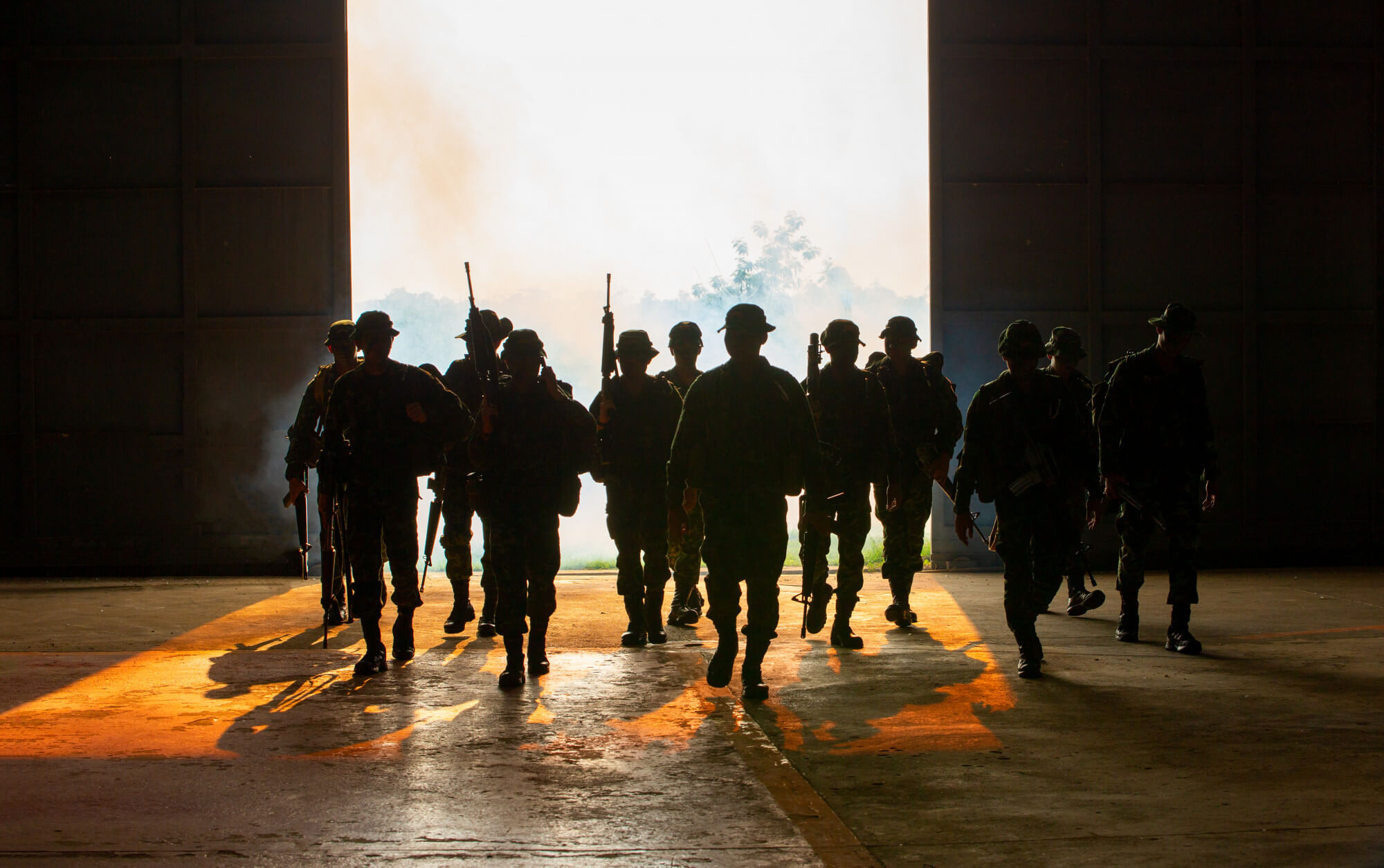 silhouette-unrecognized-soldiers-with-rifle-walk-through-smoke (1)